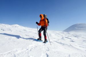 Man on snow covered mountain illustrating that dental phobia patients benefit from talk therapy.